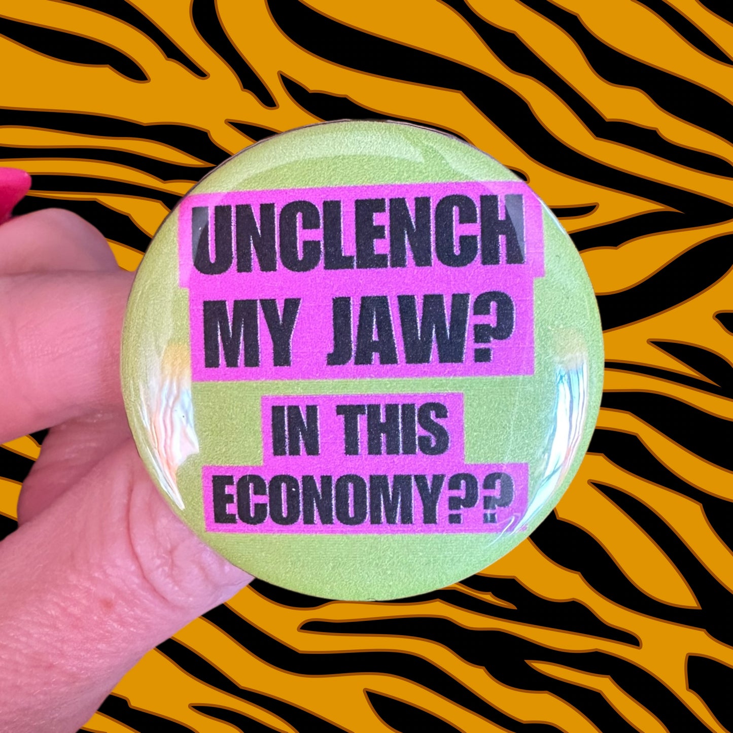 Button 1.75” diameter “unclench my jaw? In this economy??” Lime Green Pink Black