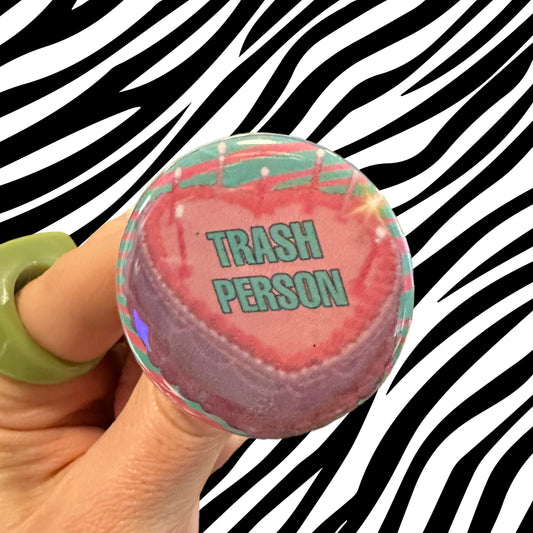 Handmade Button that is a Pink Cake that Reads “Trash Person” in Teal Funny Button